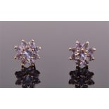 A pair of 9ct yellow gold and tanzanite floral cluster earrings each set with nine round cut pale