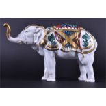 An early 20th century ceramic humidor tobacco jar in the form of an elephant with hand painted and