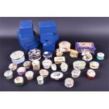 A collection of Halycon Days enamelled music and trinket boxes of varied designs to include