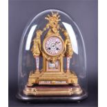 A 19th century French gilt metal mantel clock the pink porcelain dial with Roman numerals, flanked