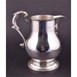 A large George V silver jug London 1927 by Crichton Brothers, of plain bulbous form, on a