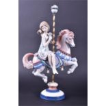 A Lladro figure of a young girl on a merry go round marked to base, 40 cm high.  CONDITION REPORT In