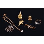A small quantity of yellow metal items, to include a Buddha charm a parrot charm, a birdcage