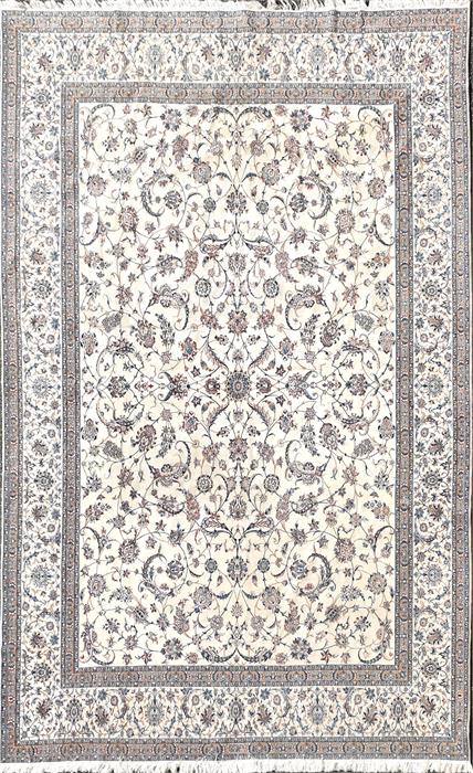 A large Persian ivory ground wool and silk Isfahan carpet decorated with a central field of