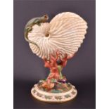 A Royal Worcester vase in the form of a conch shell raised on a stylised coral support above a