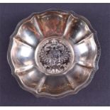A small silver bowl, its base formed with a 1780 Maria Theresa Thaler silver coin with a pie crust