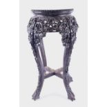 A 19th century Chinese carved and stained hardwood jardiniere stand  the circular top with inset