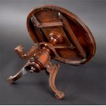 A 19th century miniature walnut veneer apprentice table the circular tilt-top inlaid with a flower