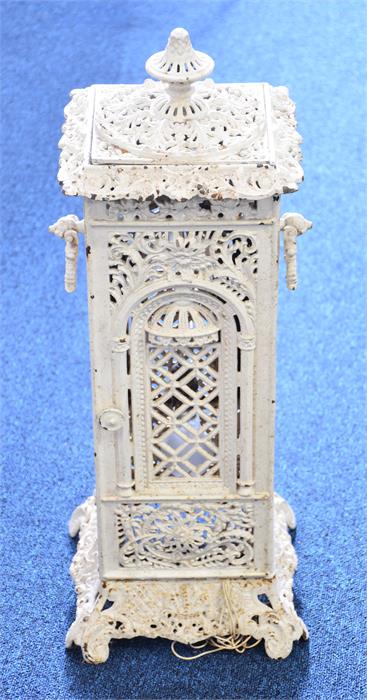 A Victorian cast iron garden heater white painted with pierced decorations and carrying handles,