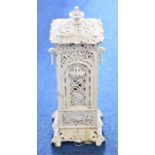 A Victorian cast iron garden heater white painted with pierced decorations and carrying handles,