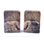 A pair of early 20th century Chinese carved and polished soapstone bookends Each decorated with