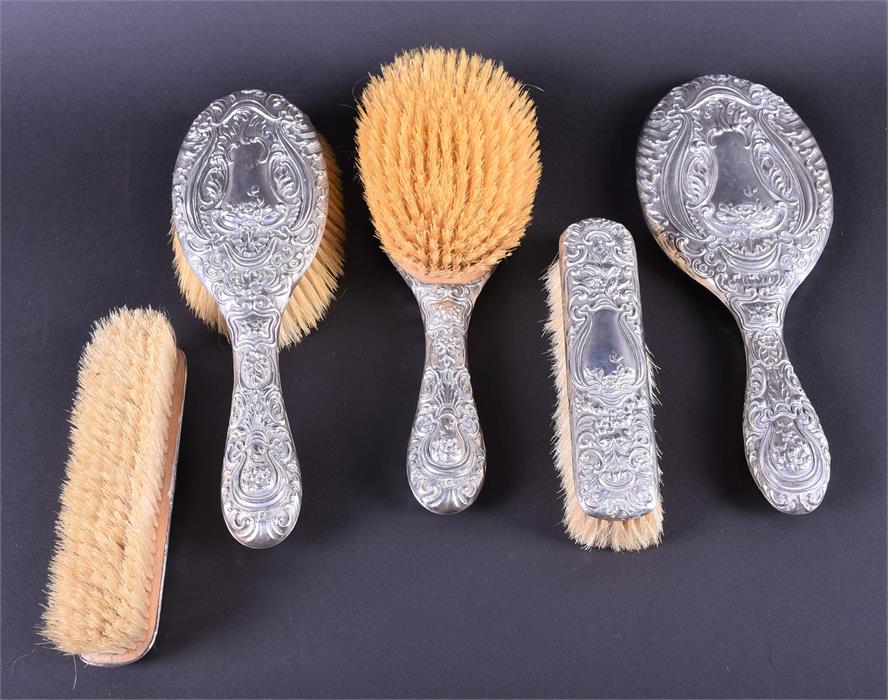 A silver vanity set Birmingham 1903, comprising: two hair brushes, two combs and a hand mirror,