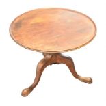 A George III mahogany tilt-top supper table with cut down base, supported on turned column, and