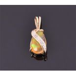 A 9ct yellow gold mounted opal pendant set with an pear-drop cabochon opal, the swirled mount set