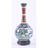 A late 19th/early 20th century Chinese bottle vase  of footed globular form with drawn neck and