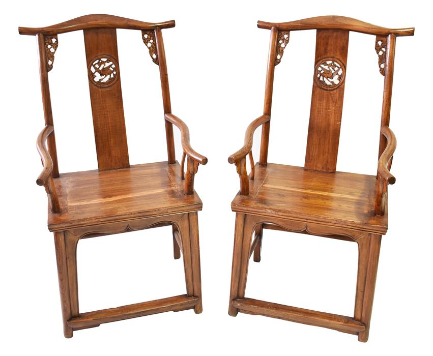 A pair of Chinese hardwood armchairs with back splats decorated with pierced griffin decoration,