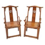 A pair of Chinese hardwood armchairs with back splats decorated with pierced griffin decoration,