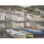 A small Cornish harbour on a Summer's day the harbour-side houses reflected in the calm water,