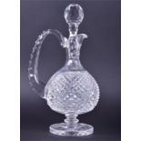 A Waterford Crystal glass decanter  with a textured handle and baluster body on a circular foot,