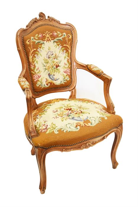 A 20th century French fruitwood fauteuil chair with needlework back, seat and arms, with foliate