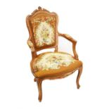 A 20th century French fruitwood fauteuil chair with needlework back, seat and arms, with foliate