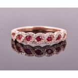 An 18ct rose gold, diamond, and ruby ring the decorative rope twist mount set with a line of seven