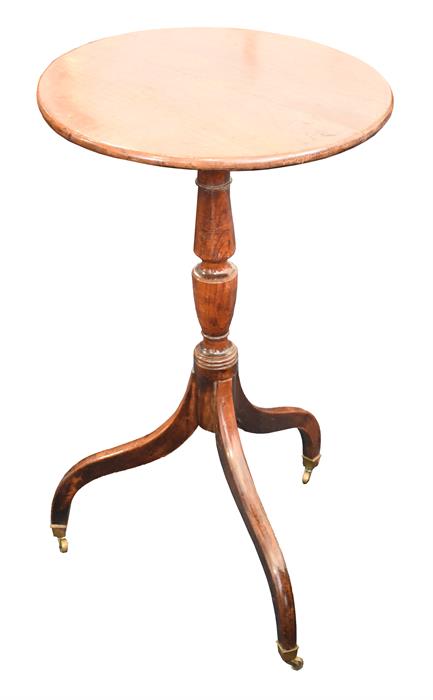 A 19th century oak wine table with circular top, supported on turned baluster column, tripod legs