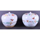A pair of Chinese porcelain jars and covers the globular bowls hand painted with warriors and