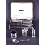 A selection of silver items to include a preserve spoon, a cased condiment trio and a set of six