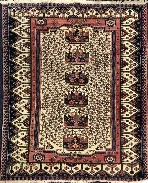 A Persian cream ground woollen rug decorated with six geometric shapes, surrounded by flowers,