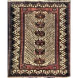 A Persian cream ground woollen rug decorated with six geometric shapes, surrounded by flowers,