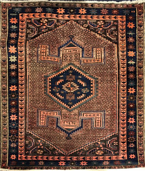 A Persian red ground rug central diamond shaped motif, flanked by geometric patterns, surrounded