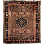 A Persian red ground rug central diamond shaped motif, flanked by geometric patterns, surrounded
