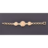 A yellow gold Art Nouveau style bracelet set with three oval segments embossed with images of