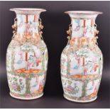 A large pair of Cantonese ceramic vases decorated in the famille rose palette of baluster form