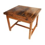 A 19th century or earlier provincial French fruit wood table the folding hinged squared top