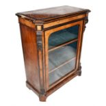 A Victorian figured walnut pier cabinet with ebonised cross-banding, single glazed door enclosing