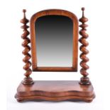 A Victorian mahogany dressing table mirror the hinged mirror between two barley twist supports,