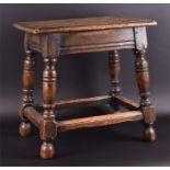 A late 19th century oak joint stool of rectangular form, supported on four turned legs and