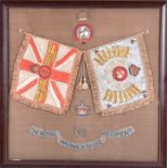 A framed embroidery from the Royal Warwickshire Regiment with two flags embroidered with place