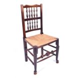 A 19th century oak spindleback chair with turned decoration and a rush seat, 96 cm high. CONDITION