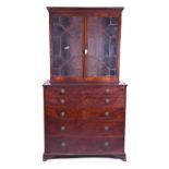 An early 19th century mahogany secretaire bookcase the top with a pair of astragal glazed doors