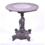 A good quality late 19th century Indian carved hardwood snap-top table the circular top carved