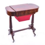 An early 19th century mahogany work table the flame mahogany top flanked by two compartments with