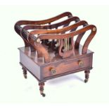 A Regency three division rosewood Canterbury with central lyre supports and gilt floral roundels,