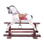 An Edwardian wooden rocking horse painted white with a black face and applied studded leather