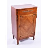 An early 20th century French kingwood cabinet the cross-banded top with canted corners, over a