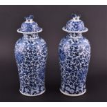 A pair of late 19th century Chinese porcelain blue and white vases and covers decorated with