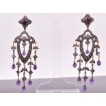 A pair of white and gilt metal, diamonds, and amethyst drop earrings the open-work mounts set with