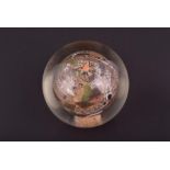 A Chinese reverse painted glass paperweight of rounded form, decorated from the inside with delicate